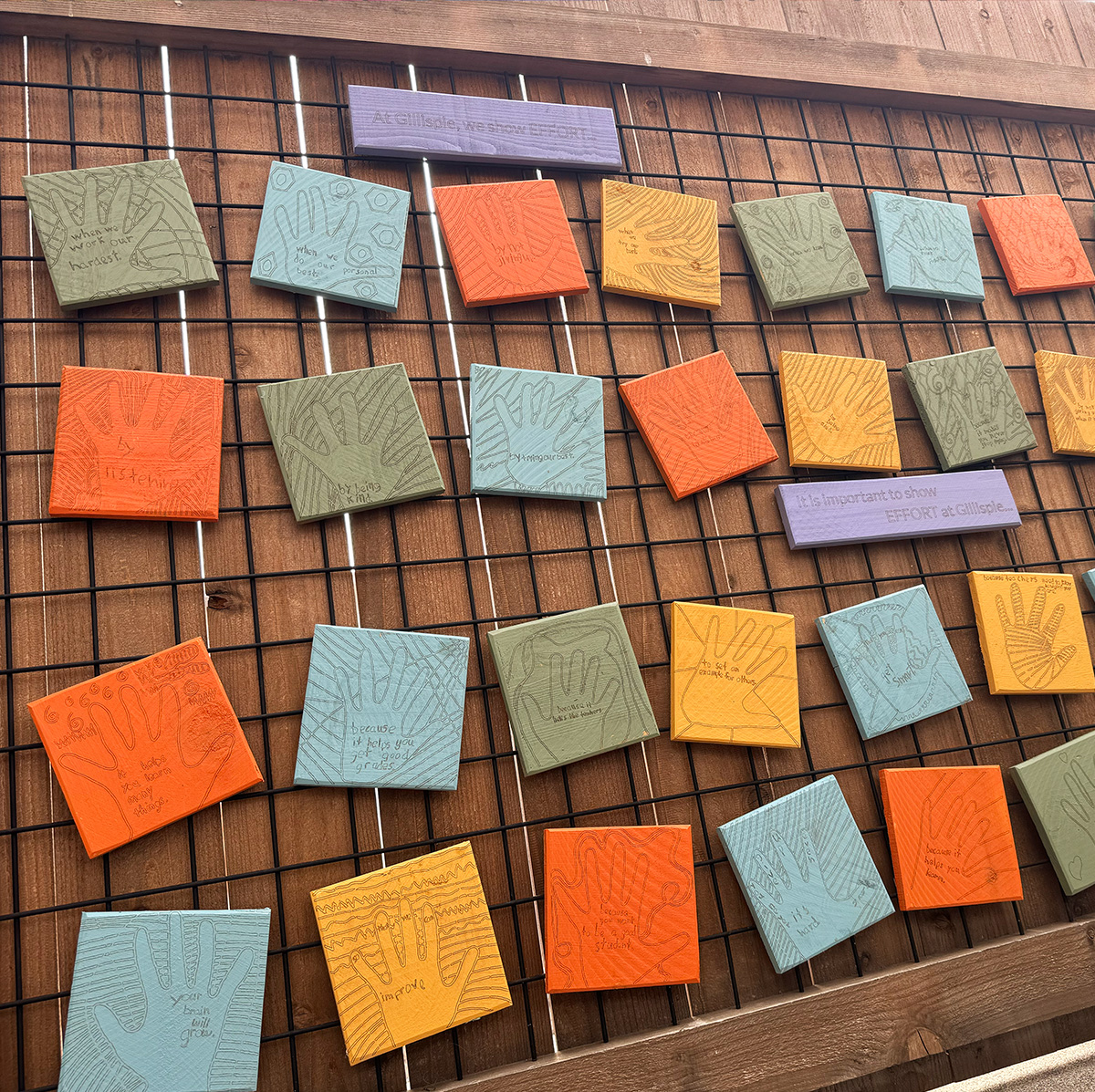 Gillispie School Community Wall with large colored tiles and values focused inscriptions created by students.